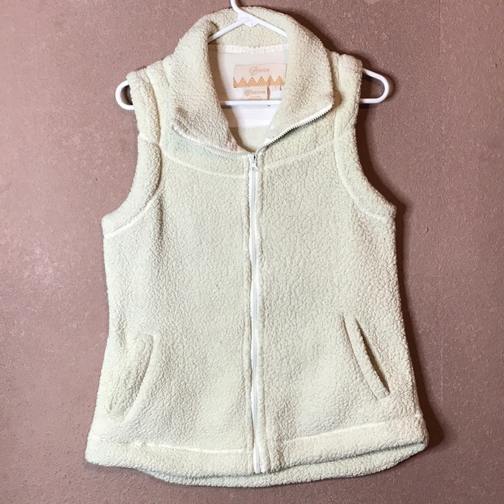 Cream colored vest.